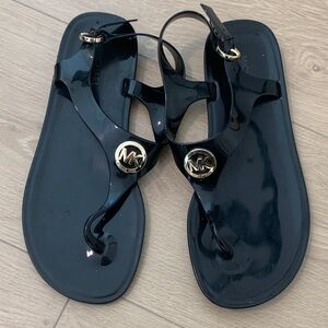 Michael Kors Glossy Black Sandals with Gold Emblem